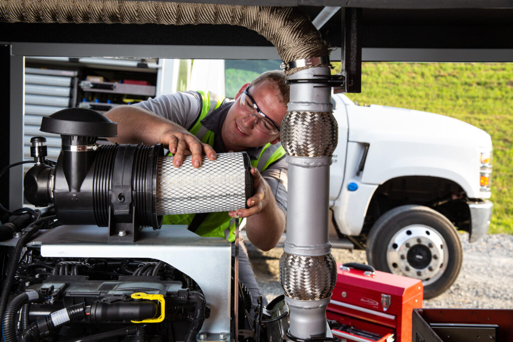 Mechanic performs air filter maintenance diesel engine